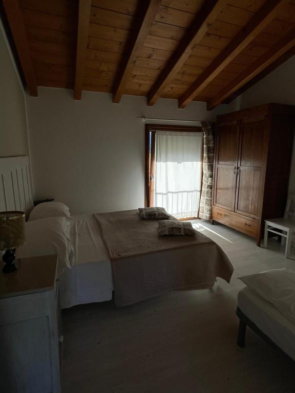 Postel nebo postele na pokoji v ubytování B&B Il Melograno