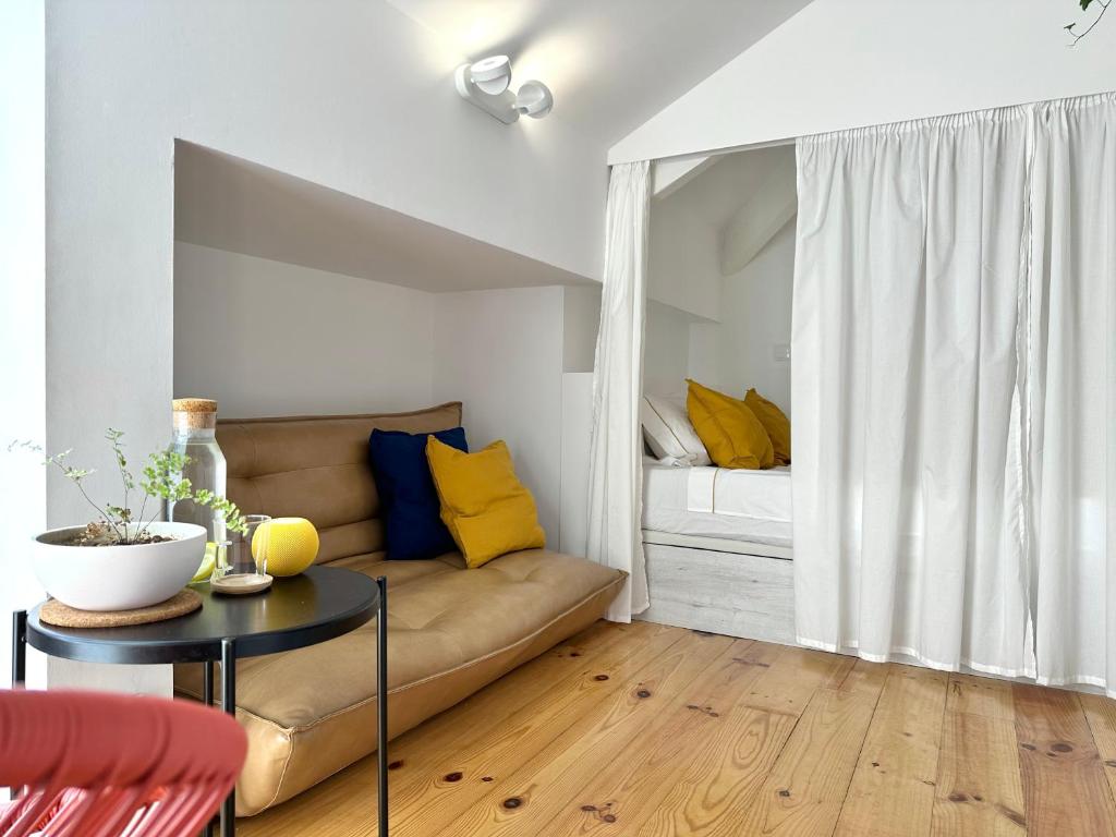 a living room with a couch and a bed at Art Cottage with oPorto View! in Vila Nova de Gaia