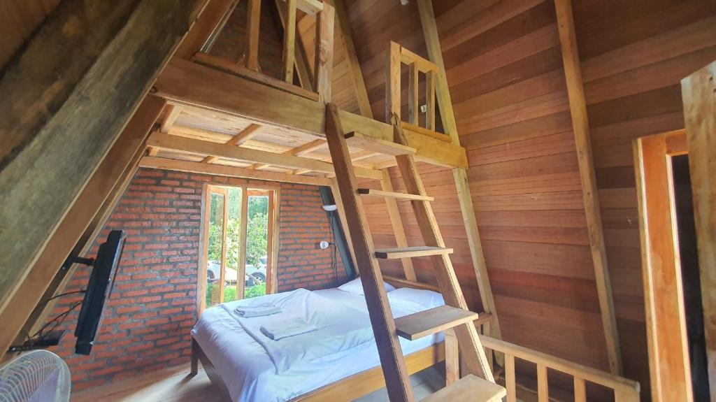 a room with a bunk bed in a tree house at Villa Lumbung Salak in Bogor