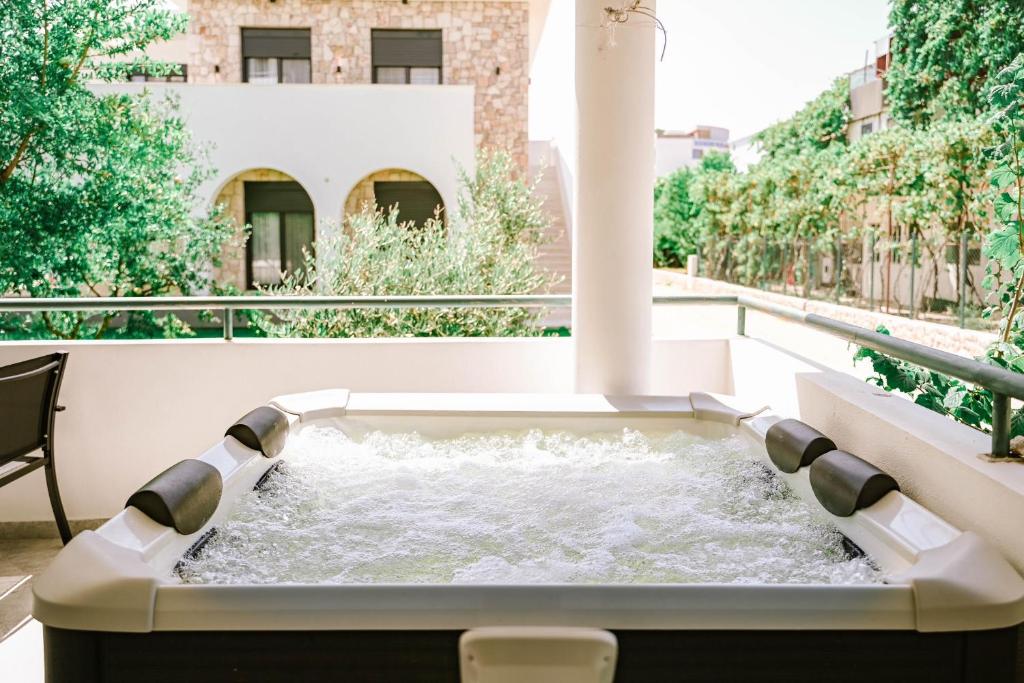 a hot tub on the balcony of a building at B&B Lovac in Ulcinj