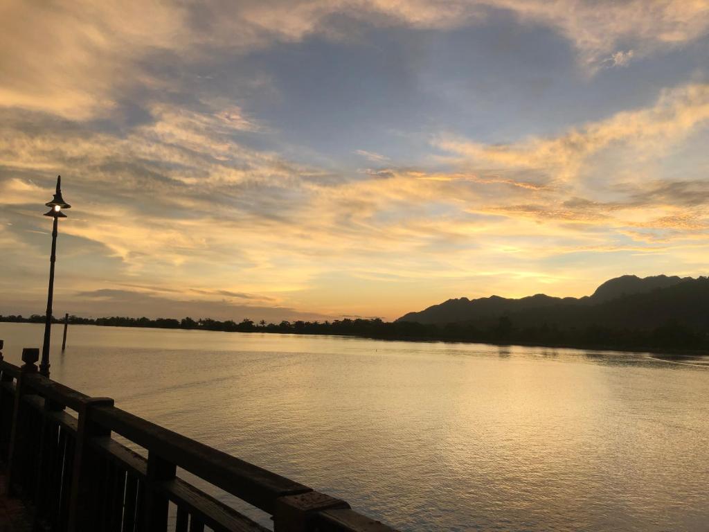 a view of a river with a sunset in the background at Langkawi Lagoon Water Villa VIP in Pantai Cenang