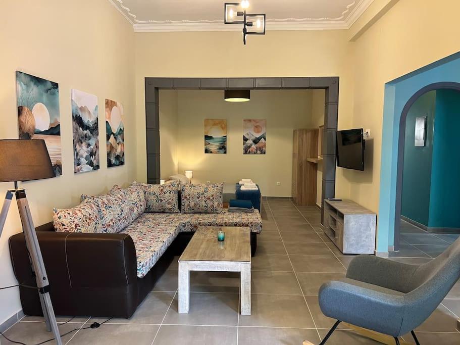 a living room with a couch and a table at Spacious and beautiful house in Piraeus