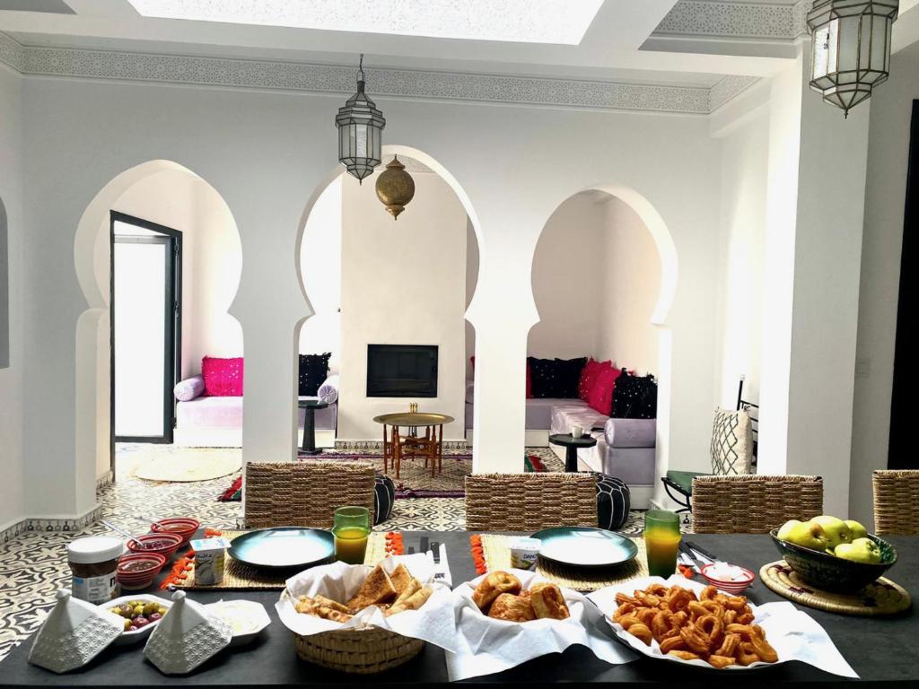 a dining room with a table with food on it at Dar Narjis in Asilah