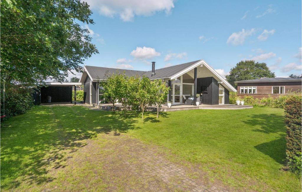 a house with a large yard in front of it at Stunning Home In Børkop in Børkop