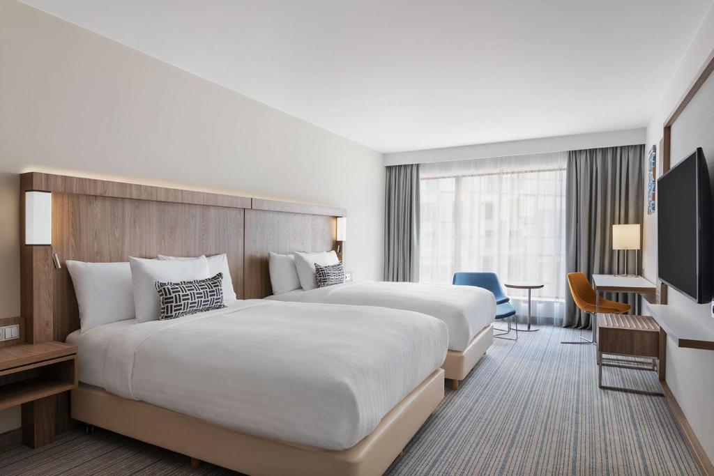 Postel nebo postele na pokoji v ubytování Courtyard by Marriott Szczecin City