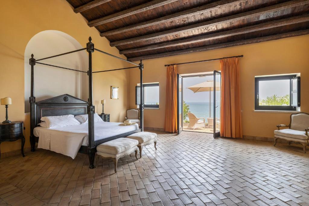 A bed or beds in a room at Falconara Greenblu Resort