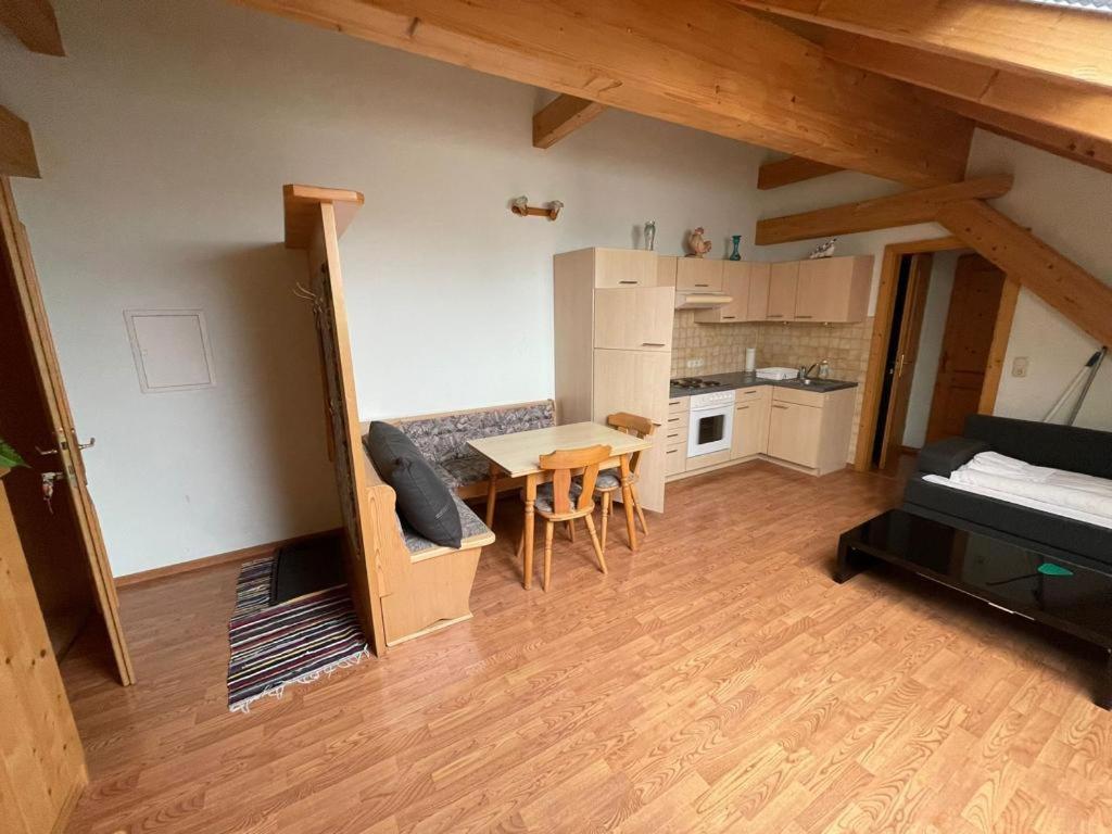 a living room with a table and a kitchen at Müllerstube in Neudorf bei Staatz