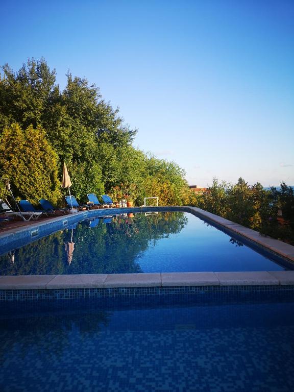 a large swimming pool with chairs and umbrellas at Seaview apt. 3 complex Karia in Kavarna