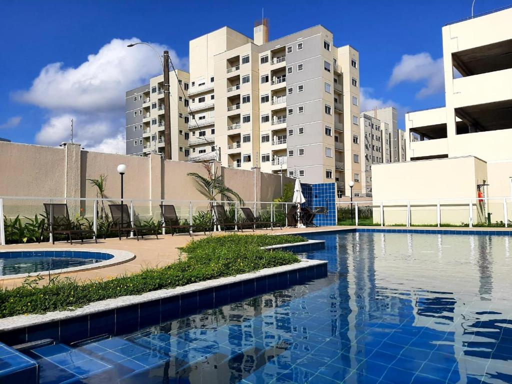 a swimming pool in a city with tall buildings at Apto novo Parque Mosaico in Manaus