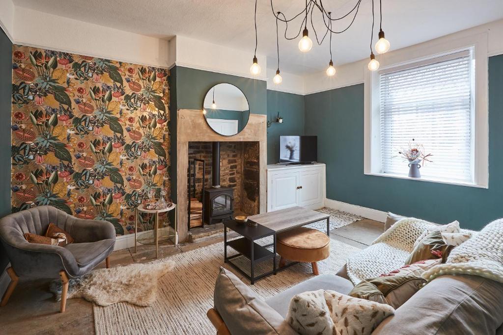 a living room with a couch and a fireplace at Host & Stay - Cobble Cottage in Lindley