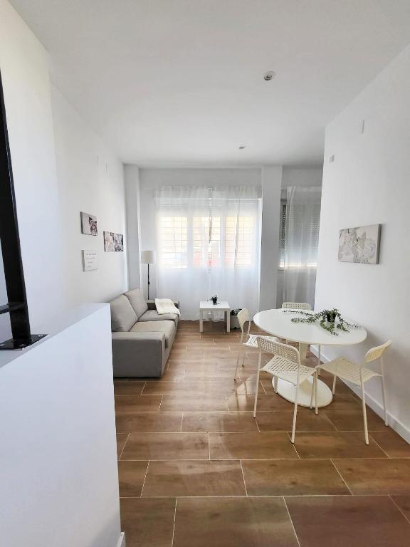 a living room with a couch and a table at Bonito piso a 300 m de Metro García Noblejas in Madrid