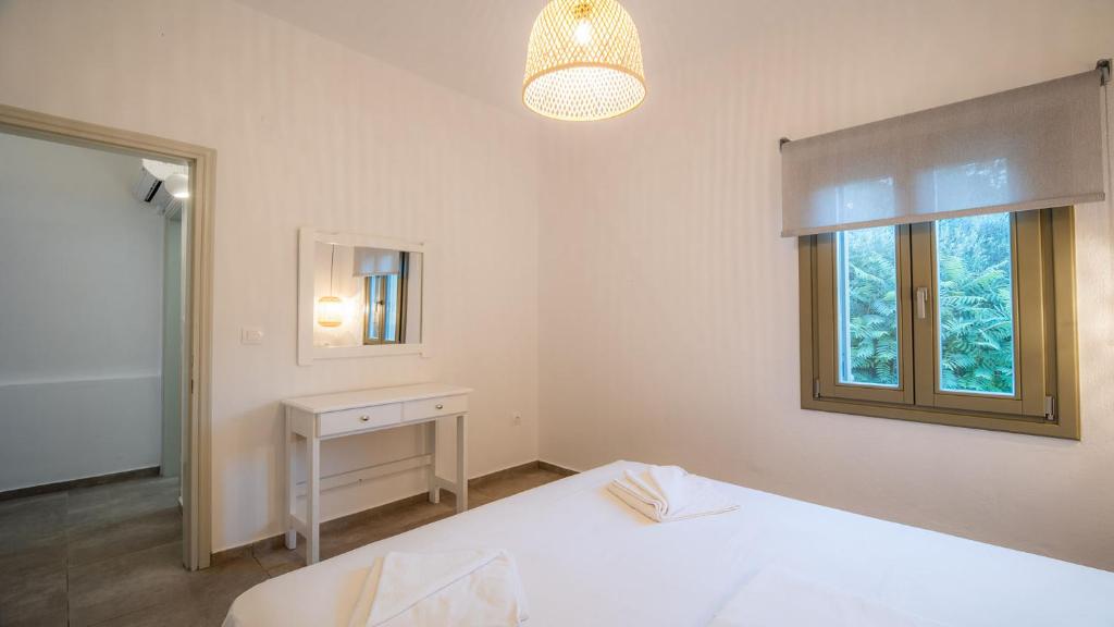 Posteľ alebo postele v izbe v ubytovaní Horto View Suites