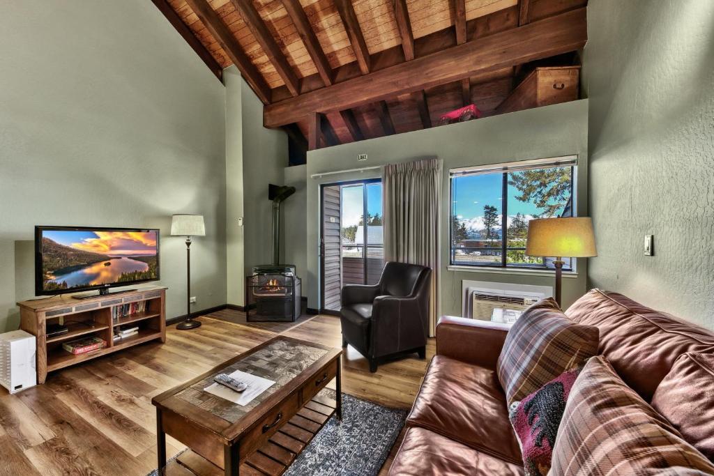 a living room with a couch and a tv at Newly Remodeled Studio plus Loft- Lakeland Village condo in South Lake Tahoe