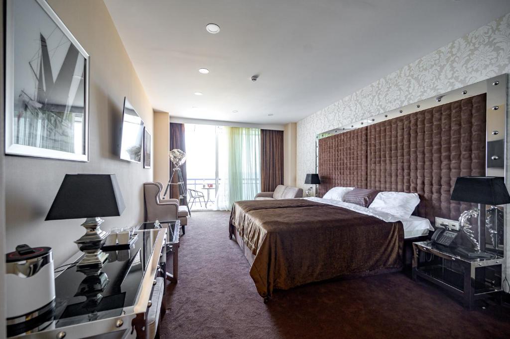 a hotel room with a bed and a large window at Apartaments Sea in Odesa