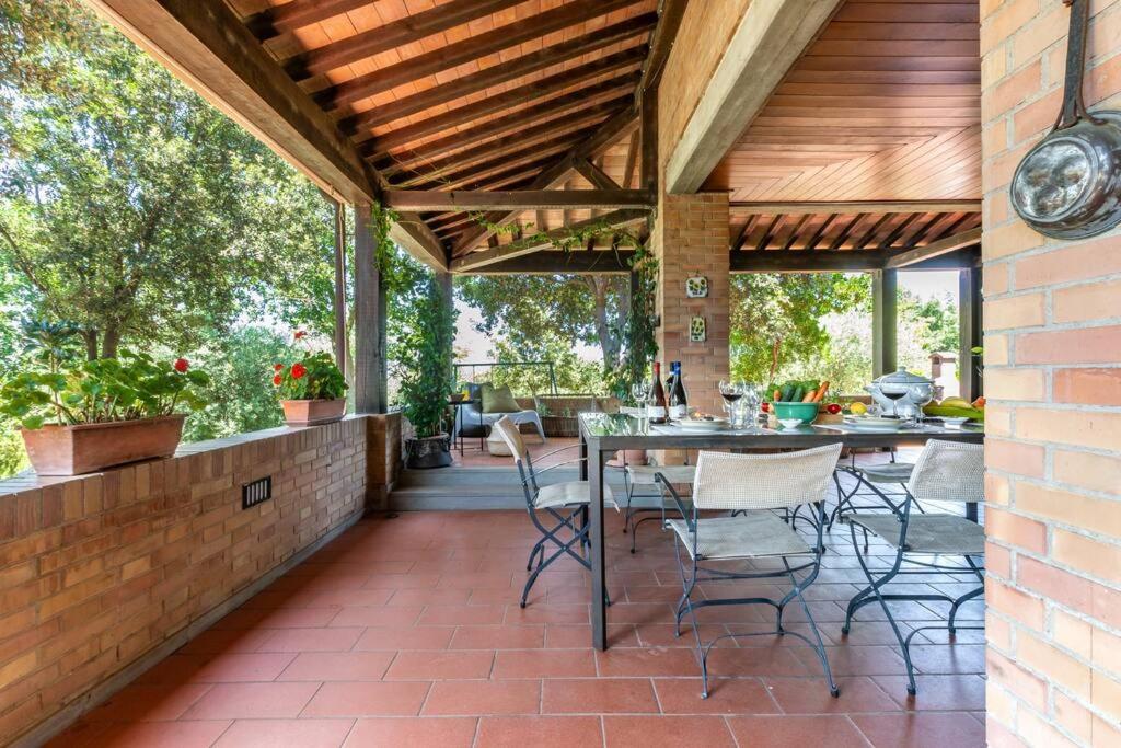 an outdoor patio with a table and chairs at Sangiovese - Villetta nella campagna toscana in Abbadia di Montepulciano