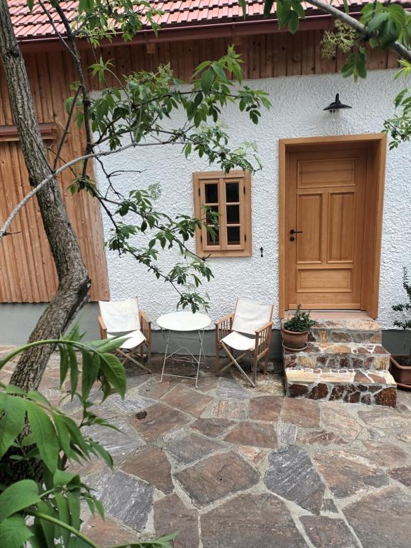 a patio with chairs and a table in front of a house at Sonnenalm in Arnfels