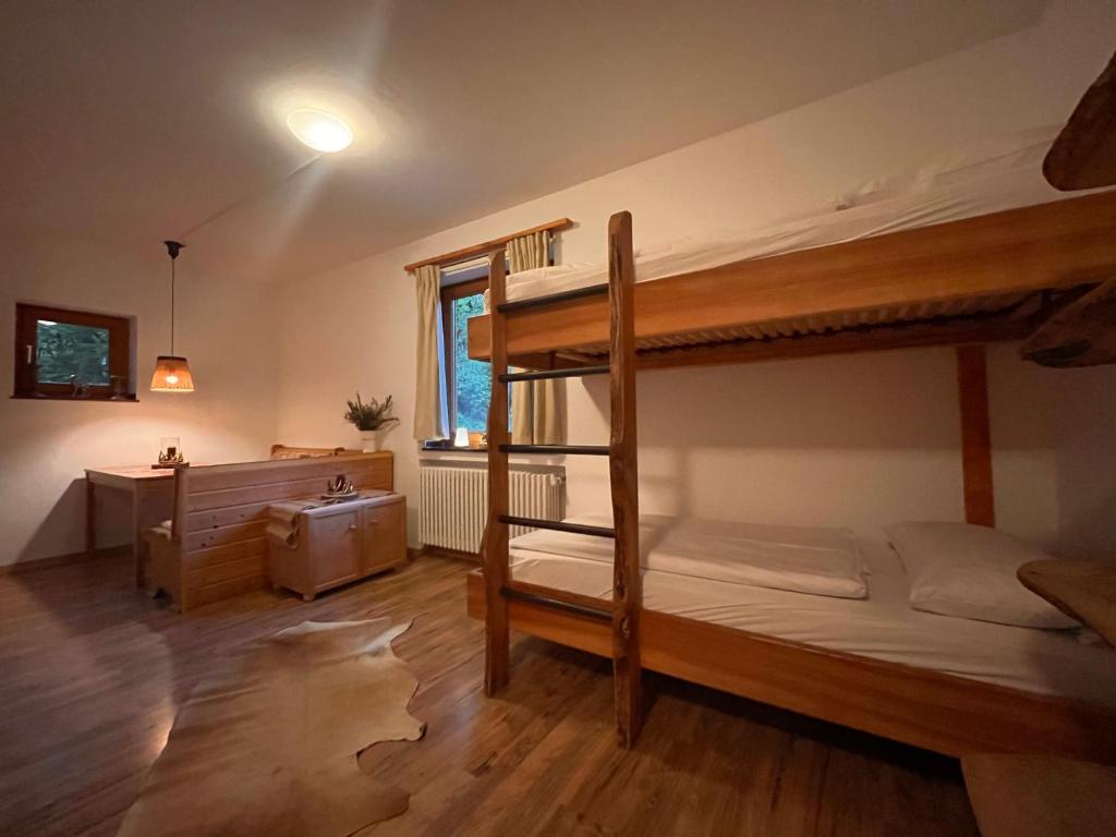a bedroom with two bunk beds and a desk at Toni Hütte am Riesserkopf in Garmisch-Partenkirchen