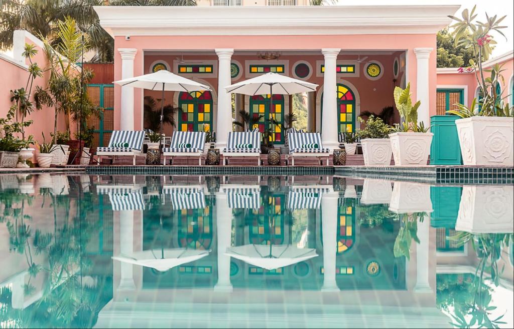 a house with chairs and a swimming pool at HOTEL WHITE RABBIT in Pushkar