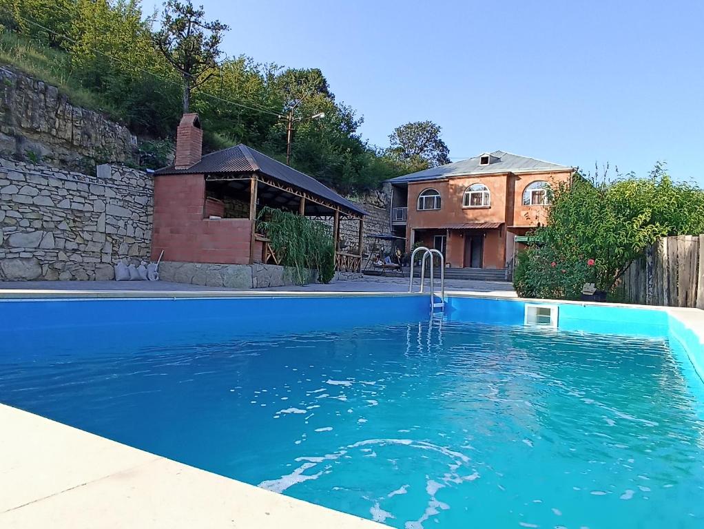 a swimming pool in front of a house at Green Garden in Ijevan