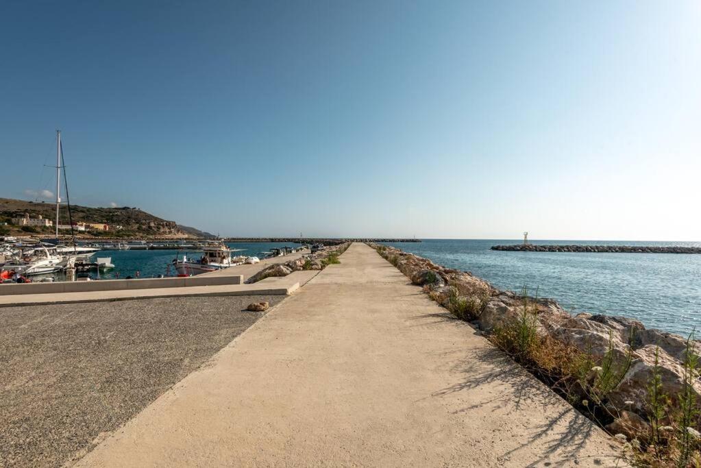 a pathway leading down to the water near a marina at SeãCret in Kolymvari