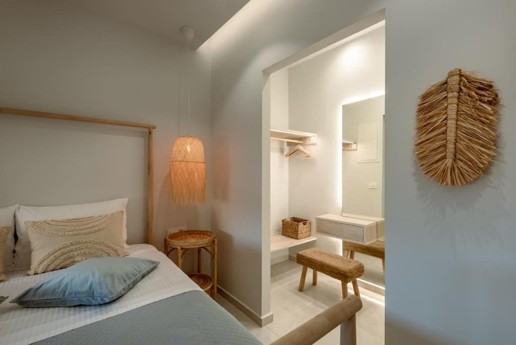 a bedroom with a bed and a mirror at SeãCret in Kolymvari