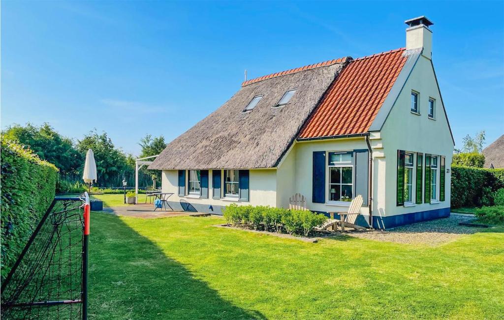 a small white house with a red roof at Nice Home In Sint Nicolaasga With House Sea View in Sint Nicolaasga