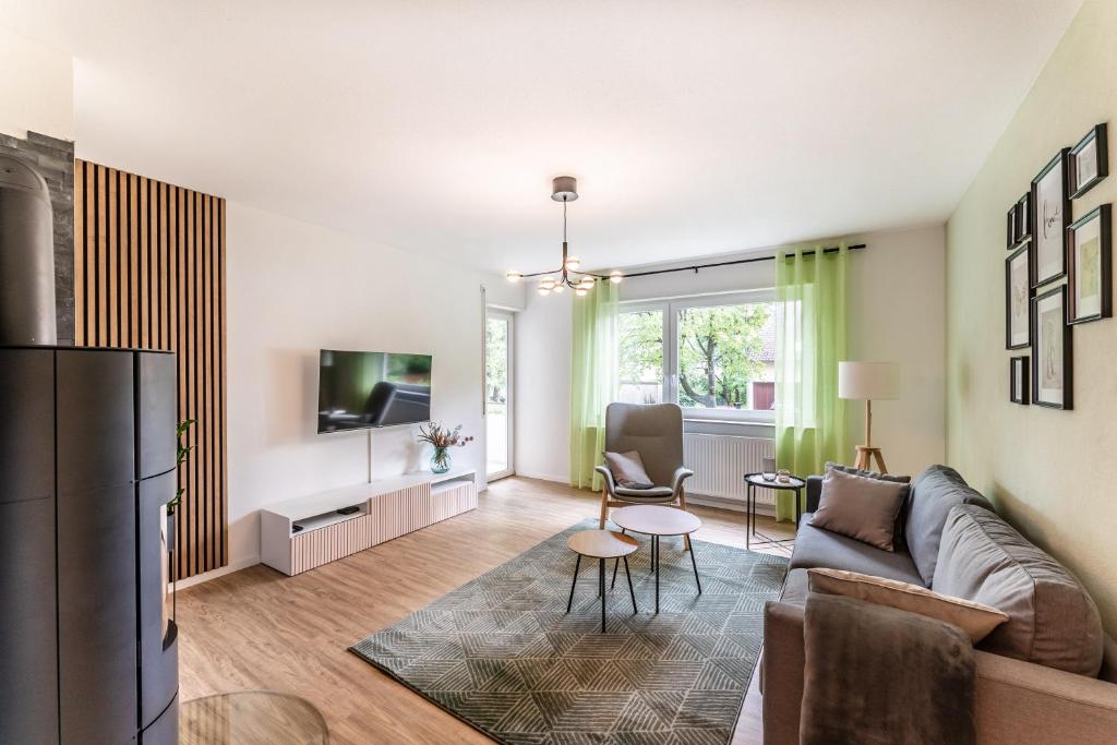 a living room with a couch and a tv at City-Luxus Apartment Rottweil in Rottweil