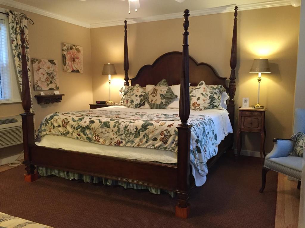a bedroom with a large bed with a canopy at Garden Walk Inn in Lookout Mountain