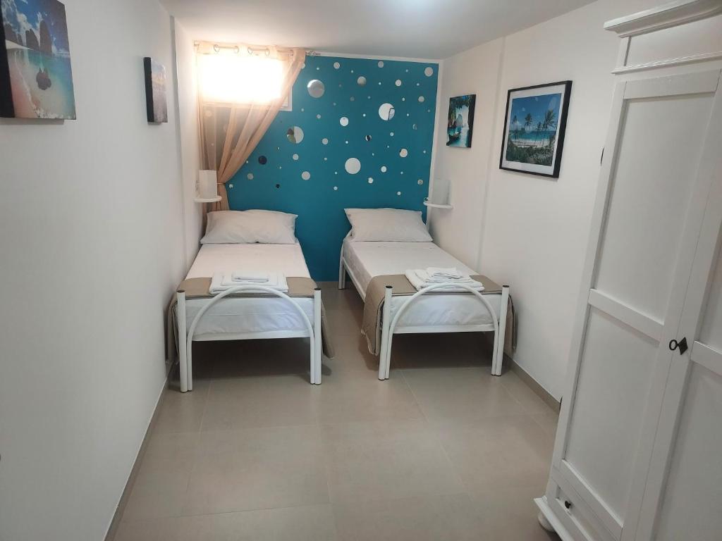 a small room with two beds and a table at Villa Capitani in Torre Canne