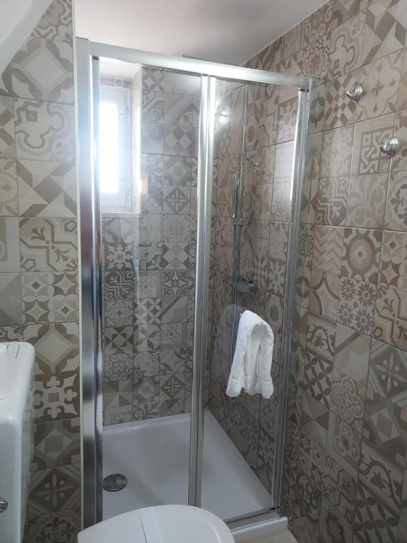 a shower stall in a bathroom with a toilet at Villa Capitani in Torre Canne