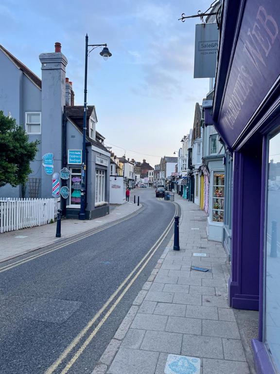 an empty city street with shops and buildings at The Bubble Hideaway - A Little Oasis near the Sea in Whitstable