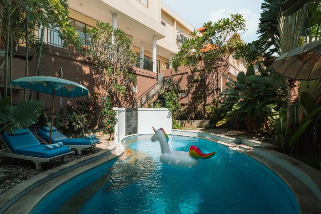 a swimming pool with a rubber duck in the water at Umah Kita in Seminyak
