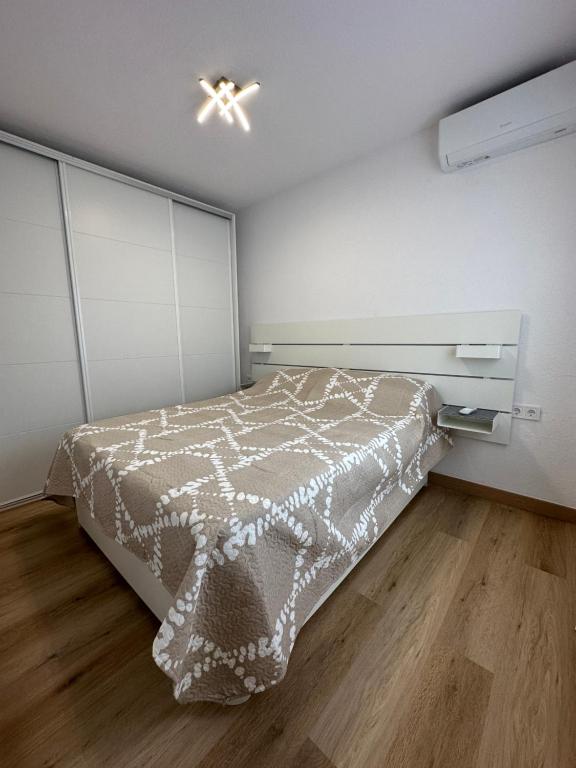 a bedroom with a bed and a ceiling fan at Antonio Apartments in Alicante