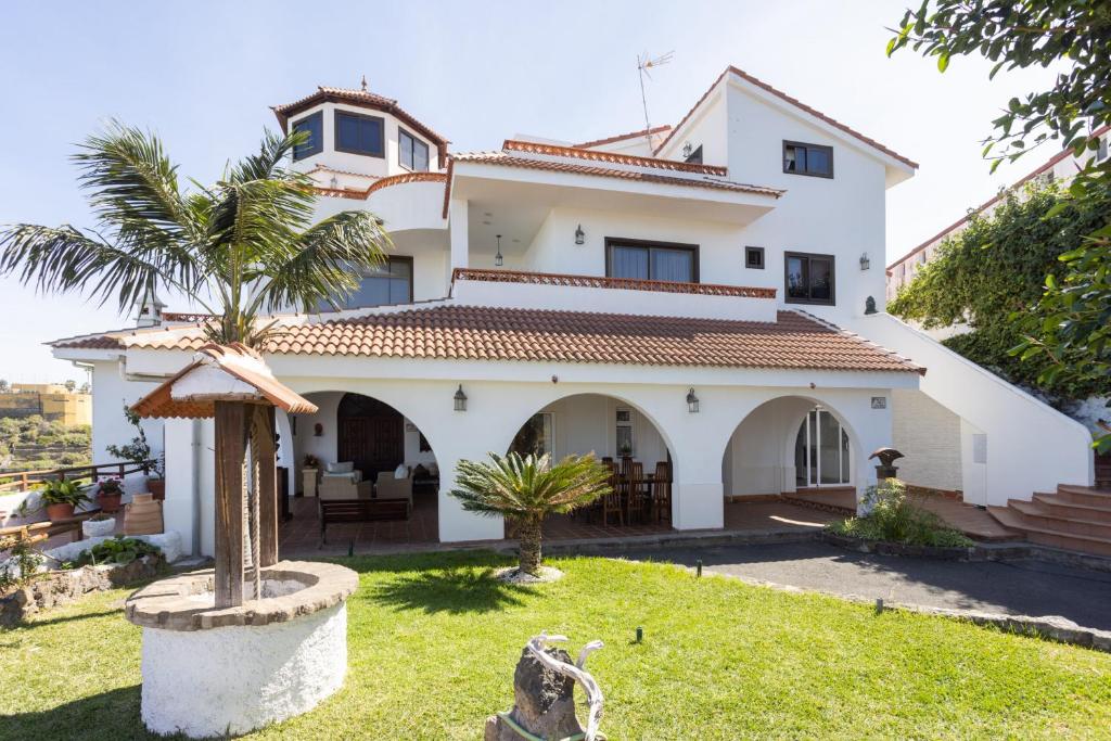 ein weißes Haus mit einer Palme im Hof in der Unterkunft Finca Villa Huerta in Icod de los Vinos