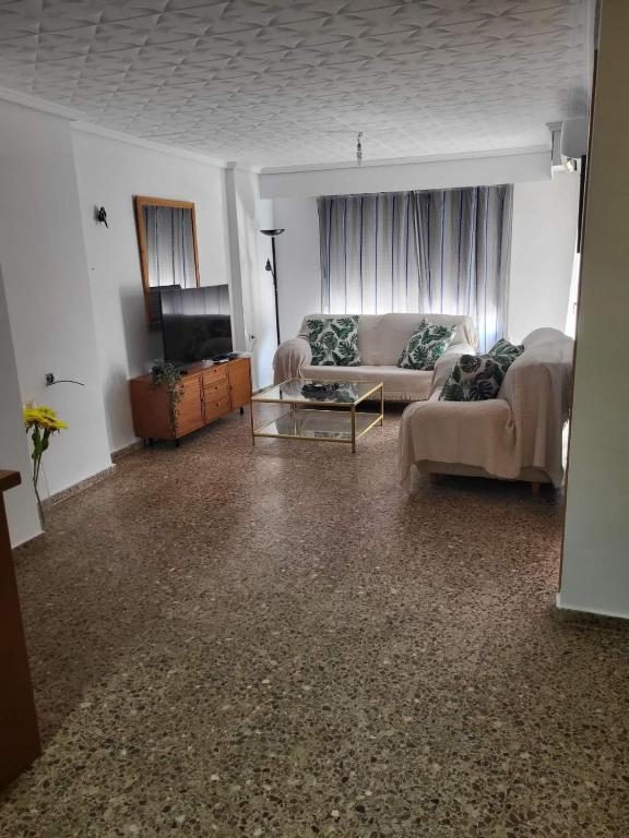 a living room with a couch and a tv at carrer de la pau port de sagunto in Valencia