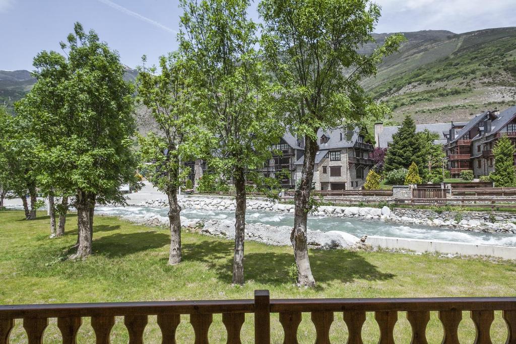 a view of a river with trees and buildings at Arties Luxury Apartments con jardín in Arties