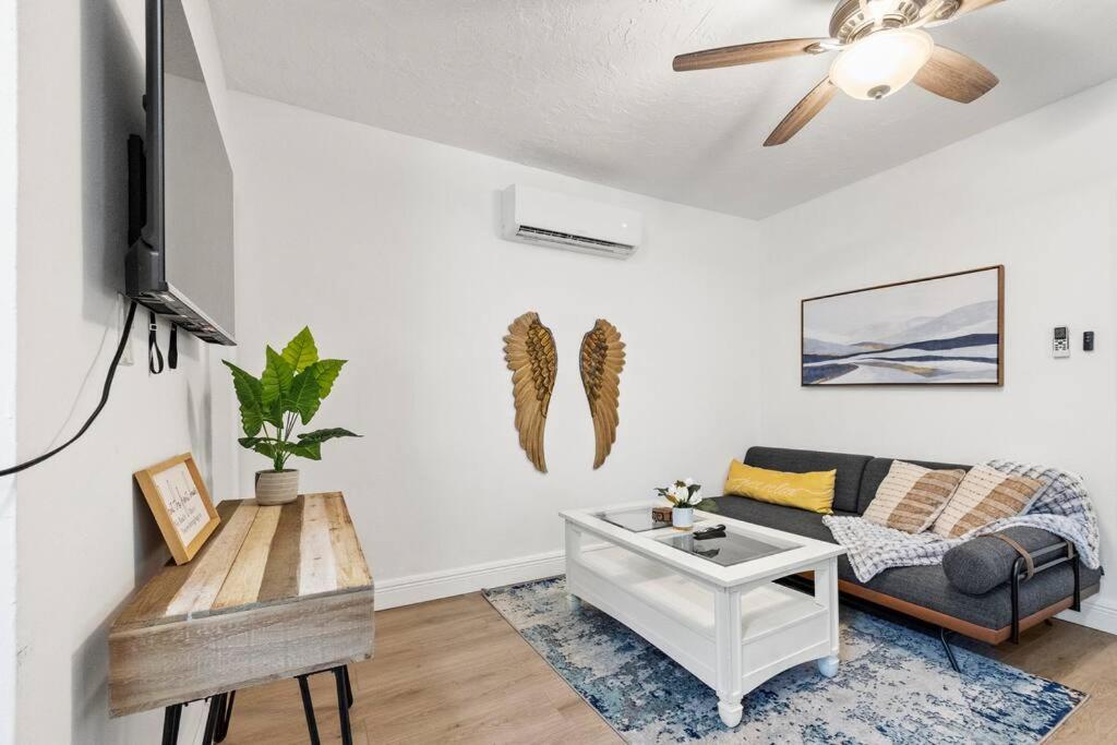 a living room with a couch and a table at Intimate Casita Mia minutes away from Airport, Calle 8, Brickell, Coral Gables, The beach and more! in Miami