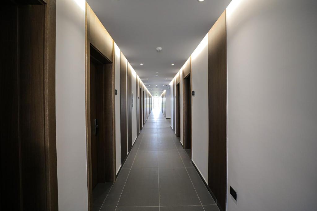 a hallway with a row of doors and a long corridor at Black Diamond Hotel Dhermi in Dhërmi