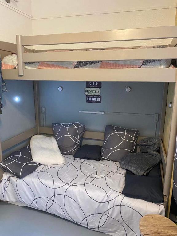 a bunk bed with pillows on it in a room at Résidence Bellevue in Wimereux