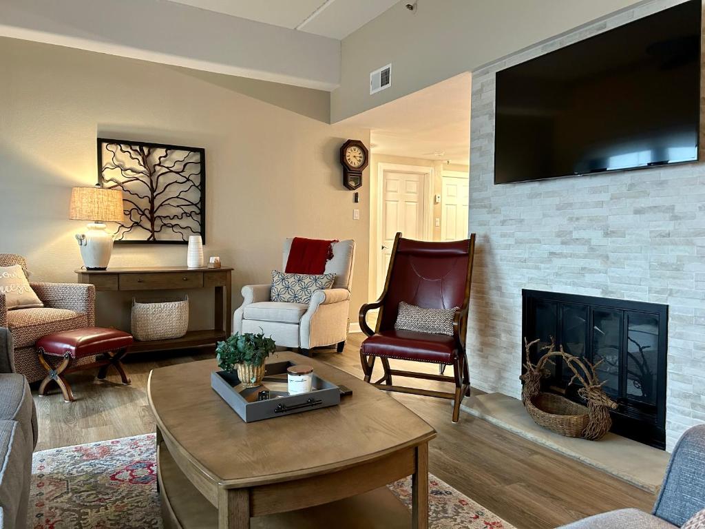 a living room with a couch and a fireplace at On top of the world at Sugar Top Resort in Sugar Mountain