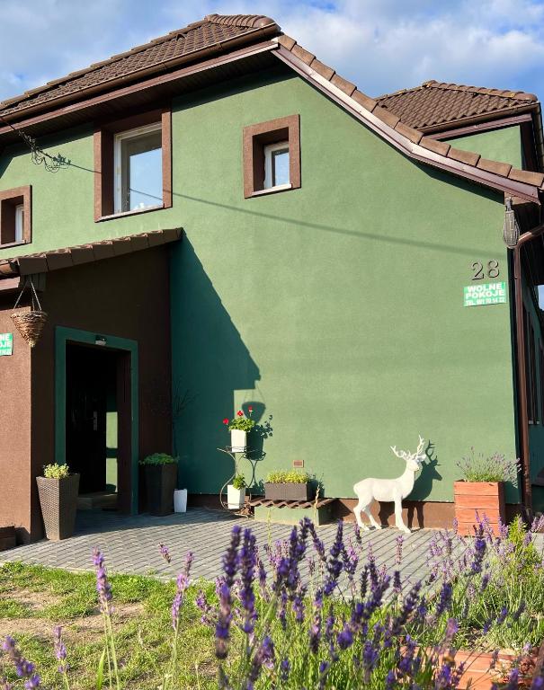 a house with a painting of a deer on the side of it at Dom nad Jeziorami in Łubowo