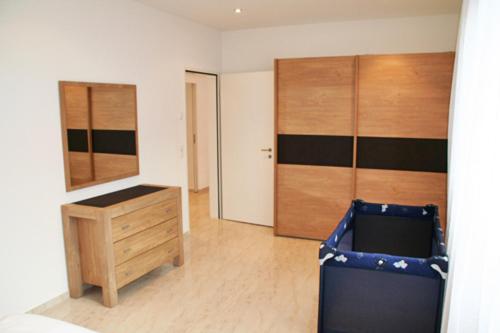 a room with a desk and a dresser in it at Nest - Bundeststrasse 6-1br in Zug