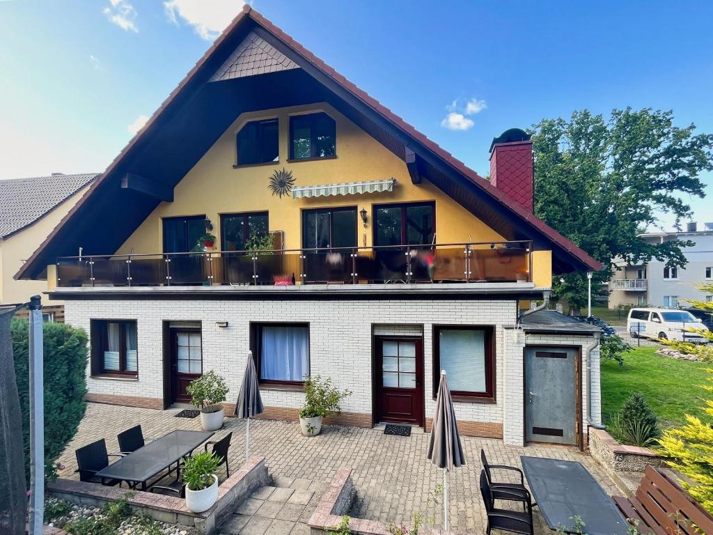 a house with a balcony on top of it at Ferienhus Baabe FeWo 01 Terrasse, Sauna- und Schwimmbadnutzung im AHOI Sellin in Baabe