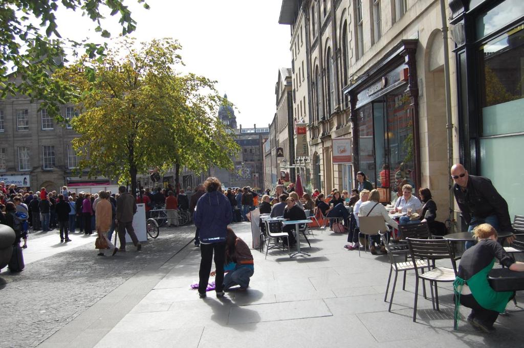 a crowd of people walking down a city street at Royal Mile Blair in Edinburgh