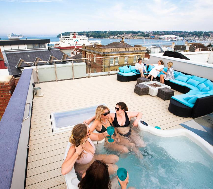 a group of women in a swimming pool on a roof at Seafarer's View - 6 bedroom townhouse in Cowes, parking & seaviews. in Cowes