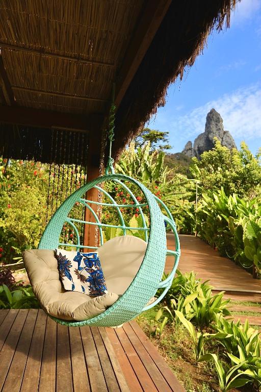 a hammock on a deck with a view at Dolphin Hotel in Fernando de Noronha