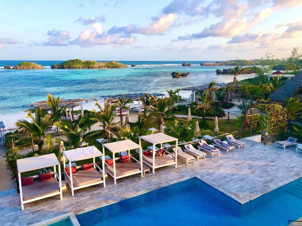 an aerial view of a resort with a pool and the ocean at Visiwa Beach Resort in Watamu