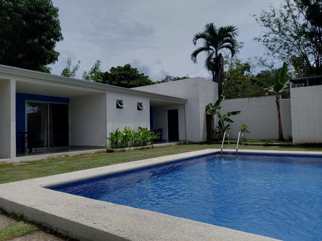 a swimming pool in front of a house at Hotel La Guarida in Palma