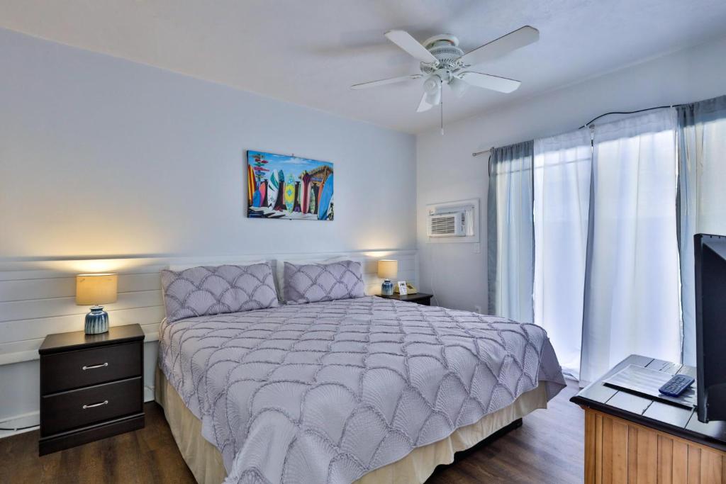 a bedroom with a bed and a ceiling fan at Coastal Waters 110 - 1 Bedroom, 1st Floor Pool Side Condo in New Smyrna Beach