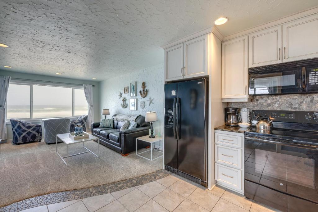 a kitchen and living room with a black refrigerator at Prime Coastal Retreat on Lincoln City Beach! in Lincoln City